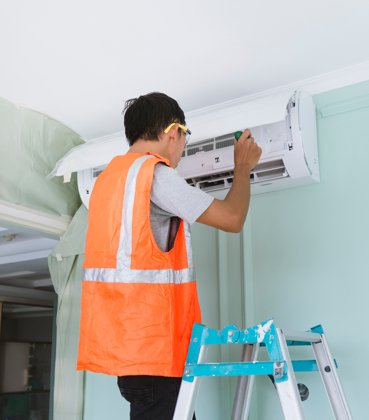 Man Repairing the Air Conditioning Unit